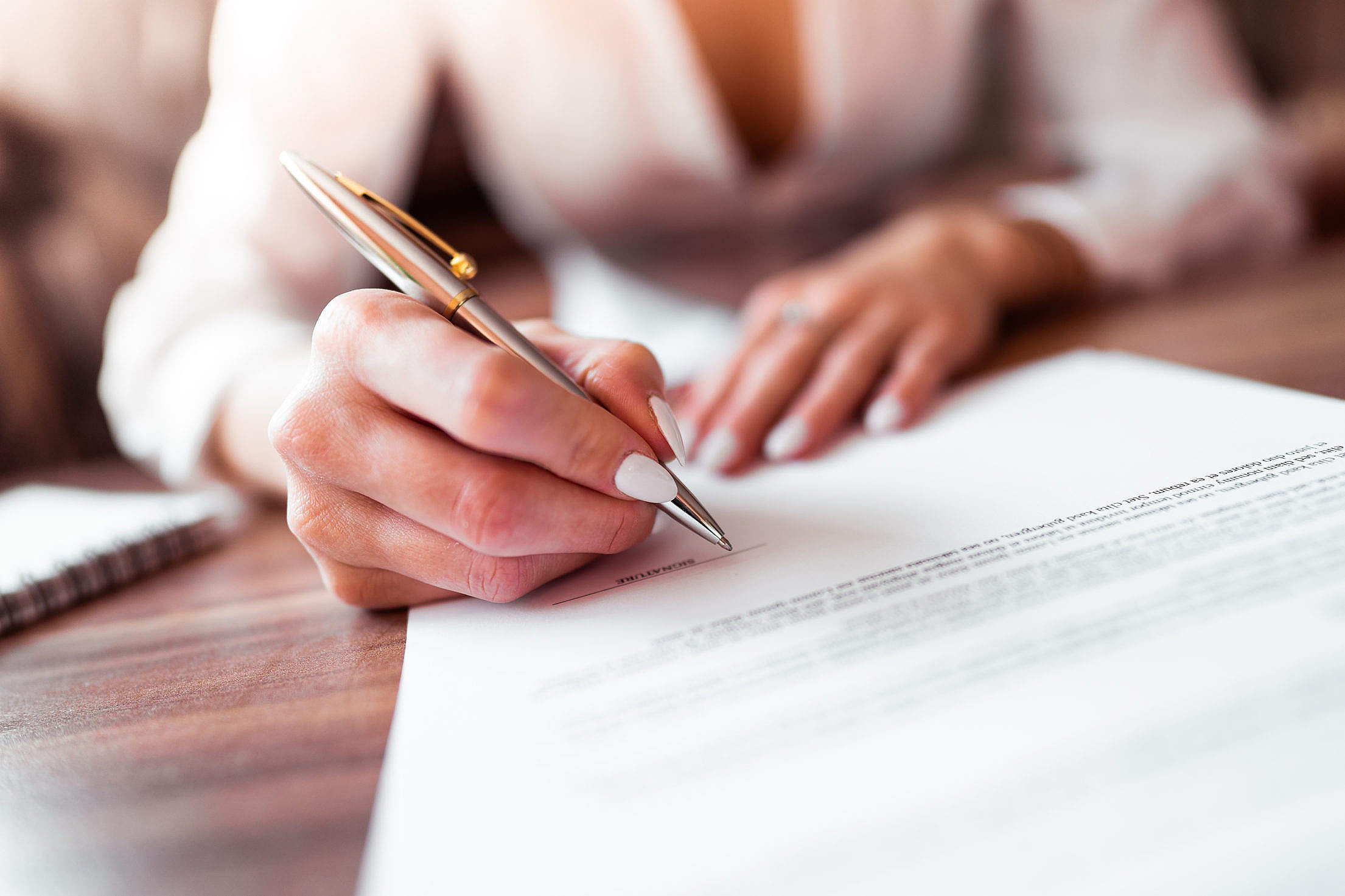 business-woman-signing-a-contract-2210x1473